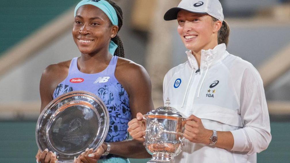 Coco Gauff and Iga Swiatek holding their trophies after the 2022 French Open final