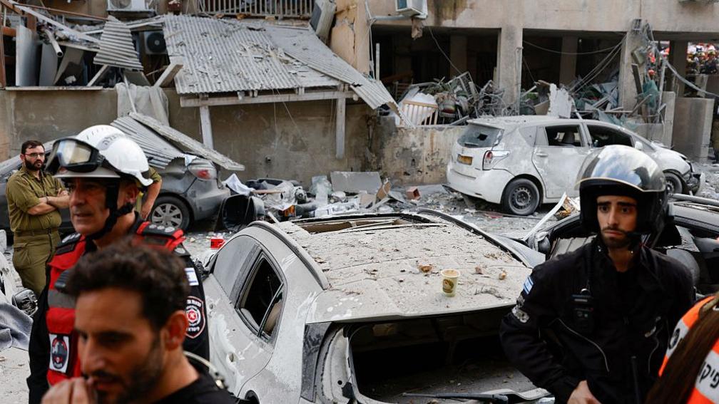 Rescuers work near a damaged building following a strike by an Iranian missile in the Israeli city of Bnei Brak on 16 June 2025