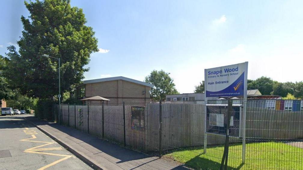 Streetview image of Snape Wood Primary School, a modern, low rise school surrounded by a high fence