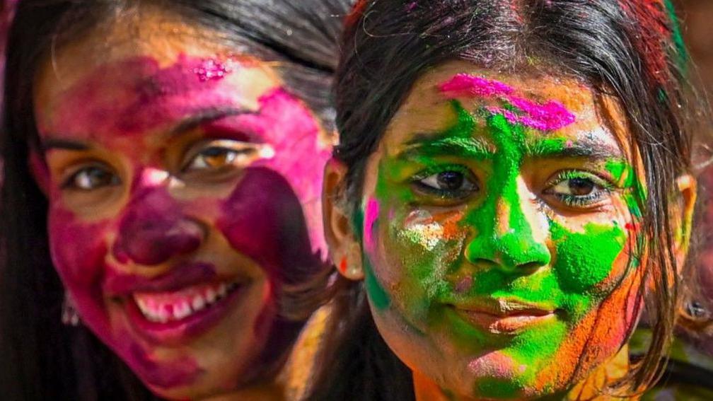 Students play with colours ahead of Holi festival, at KG Marg on March 12, 2025 in New Delhi, India. 