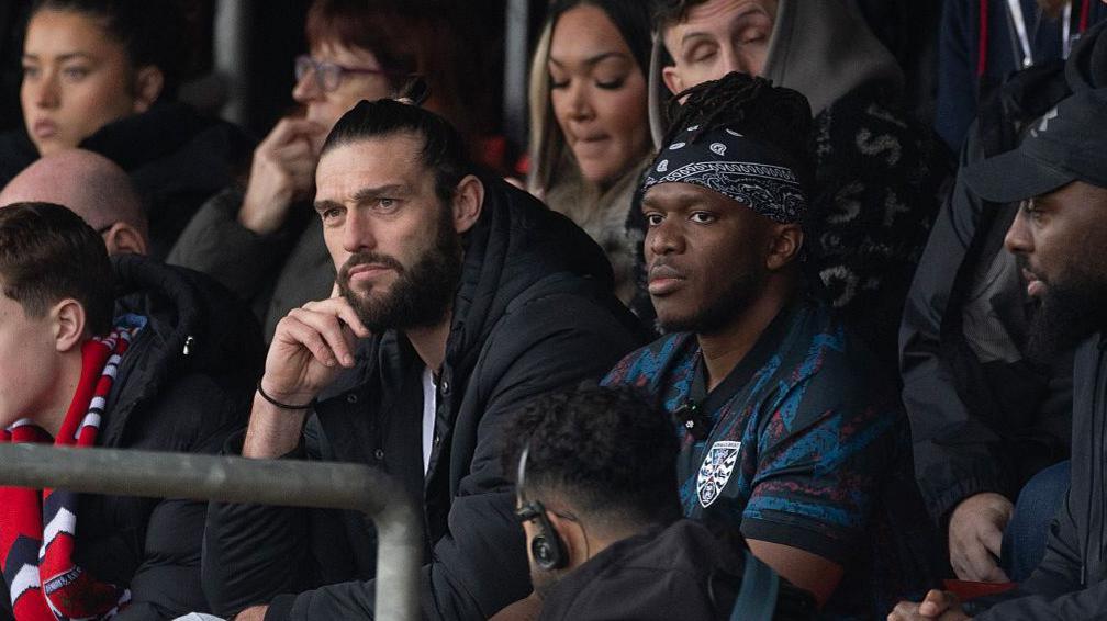 Andy Carroll and YouTuber KSI watch from Dagenham & Redbridge together against Dorking from the stands