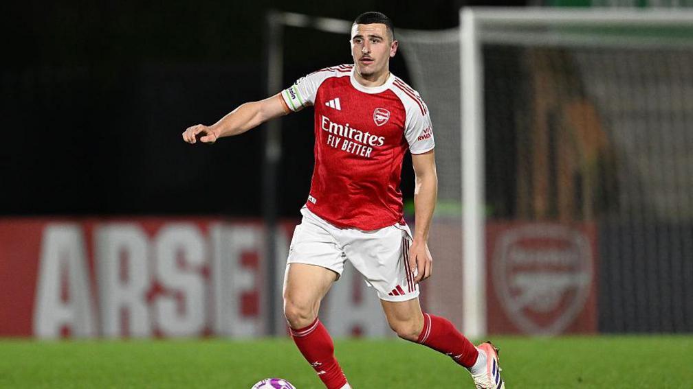 Maldini Kacurri brings the ball out of defence for Arsenal under-21s
