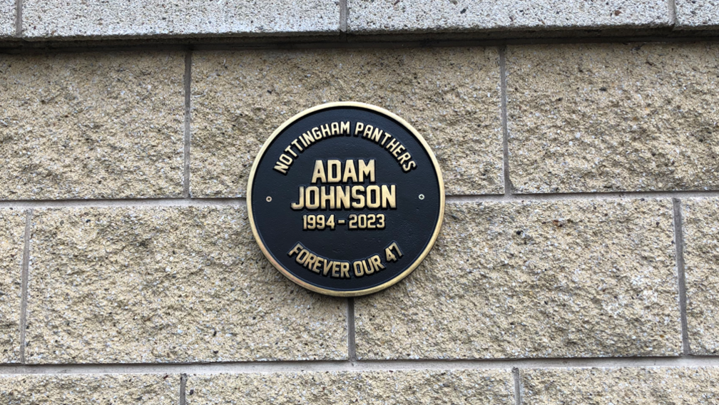 A circular black plaque placed in memory of Adam Johnson on a wall of Motorpoint Arena in Nottingham