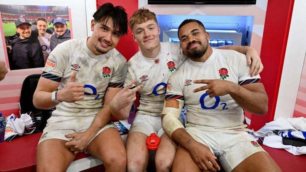 Marcus Smith of England poses for a photograph with teammates Fin Smith and Ollie Lawrence 