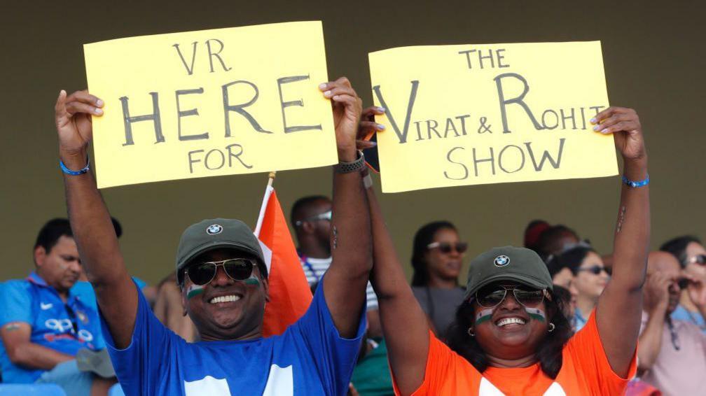  Fans of India hold signs dedicated to players Virat Kohli and Rohit Sharma in the stands prior to the ICC Men's T20 Cricket World Cup West Indies & USA 2024 Super Eight match between India and Bangladesh at Sir Vivian Richards Stadium on June 22, 2024 in Antigua, Antigua and Barbuda