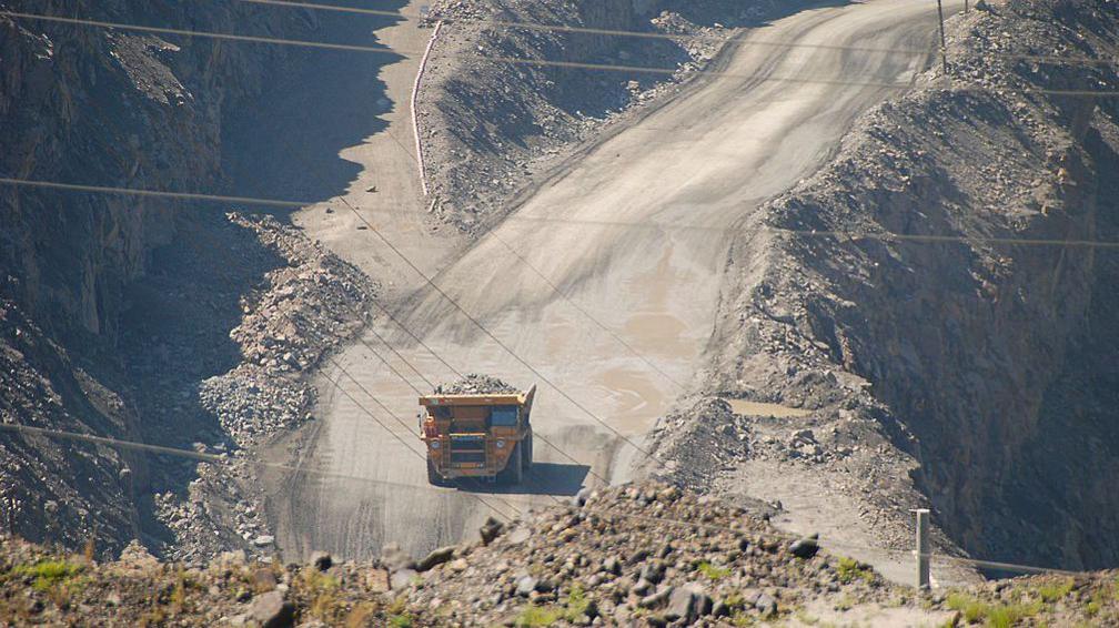 A truck goes down a road on cliffside in the Baiyun'ebo or Bayan Obo mining town in Inner Mongolia. The mines north of the town are one of the largest deposits of rare earth metals found in the world.