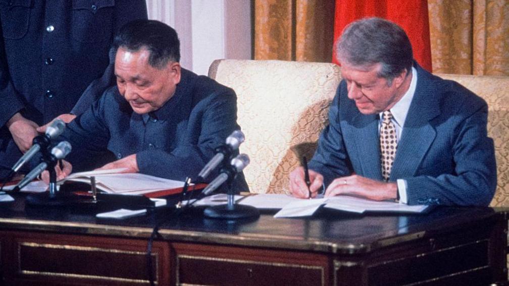 Chinese leader Deng Xiao Ping and US President Jimmy Carter signing an agreement for cooperation between China and the United States on science and technology, Washington, DC, January 1979.