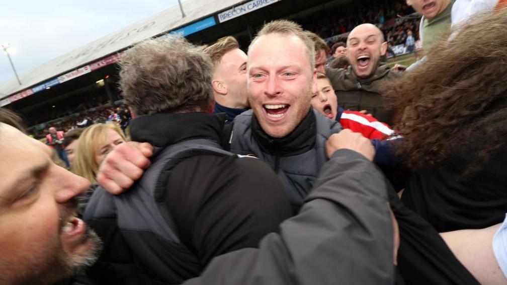 Mike Flynn is mobbed by fans after a game