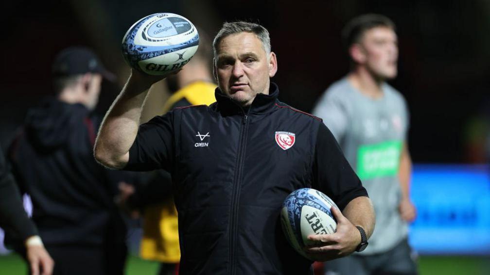 Trevor Woodman holding two rugby balls during a pre-game warm-up