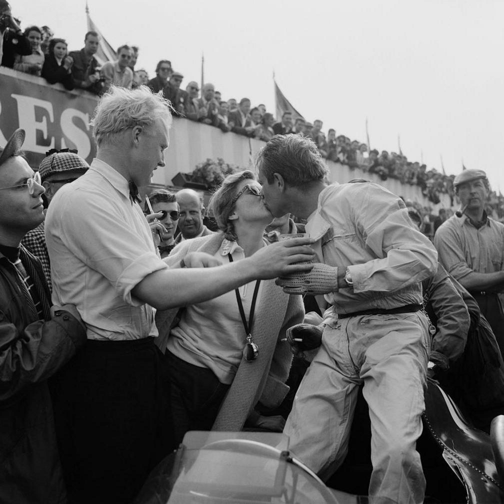 Peter Collins kisses his wife, Louise after winning at Silverstone in 1958. Handing him a drink is Ferrari team-mate Mike Hawthorn, who would become Britain's first world champion that year. Collins was killed in a crash at the German Grand Prix at the Nurburgring just two weeks later