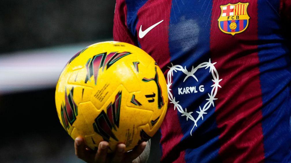 A Barcelona player holding a football