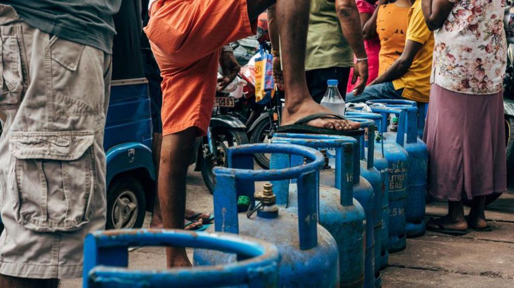 People wait in a queue for gas at the Pellawatte Litro Gas filling station in Colombo, Sri Lanka, on Sunday, May 22, 2022. S