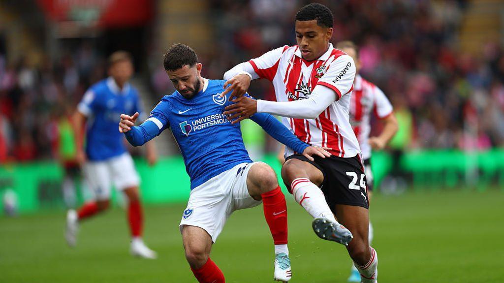 Conor Chaplin and Shea Charles battle for possession of the ball