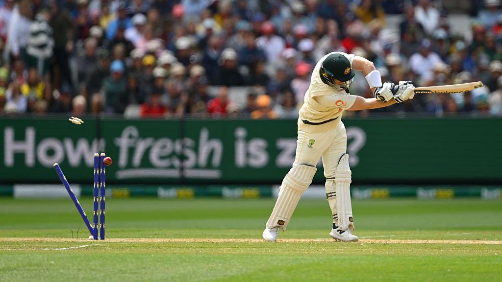 Australia's Steve Smith is bowled with the ball shown hitting the stumps