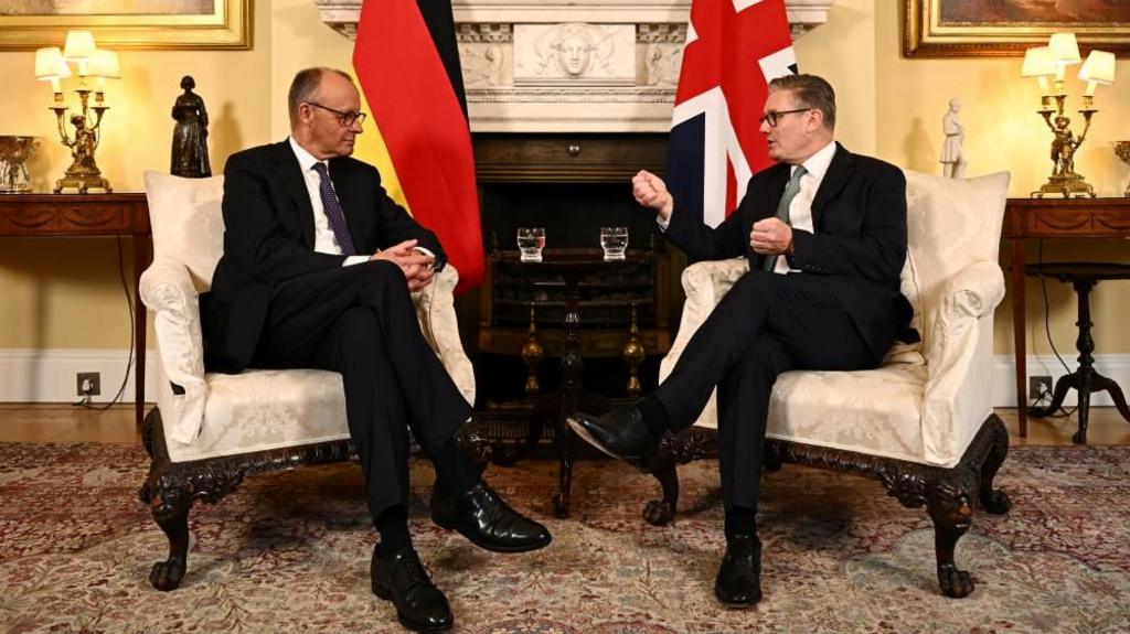 Merz and Starmer speak in No 10 wearing suits.