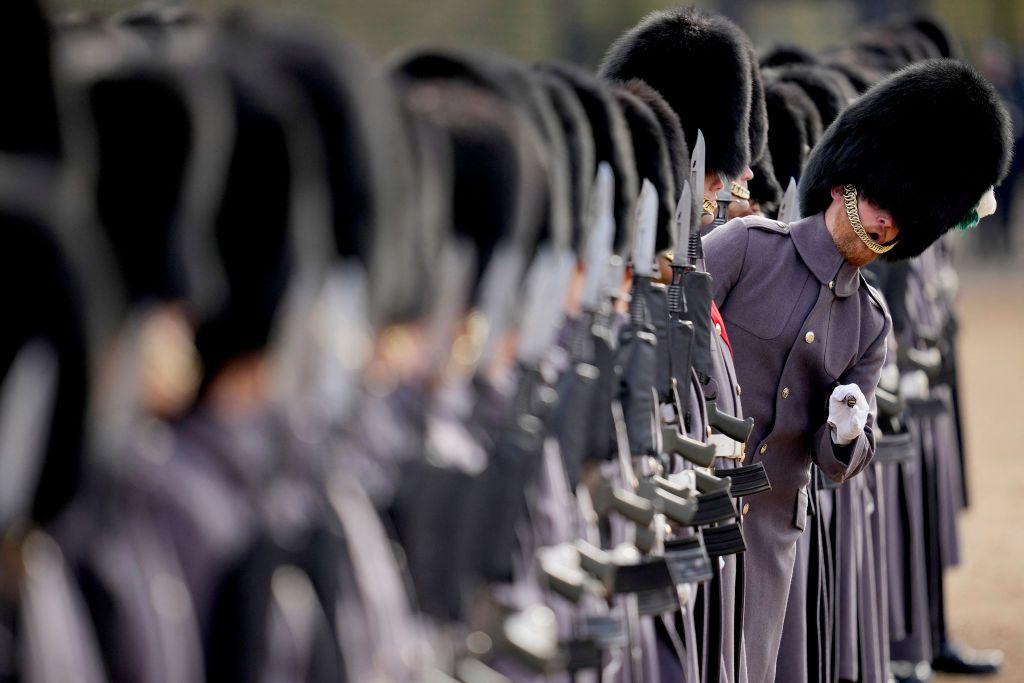 A member of the 1st Battalion Welsh Guards leans out of line as they prepare for a Ceremonial Welcome for the Emir of Qatar and his wife