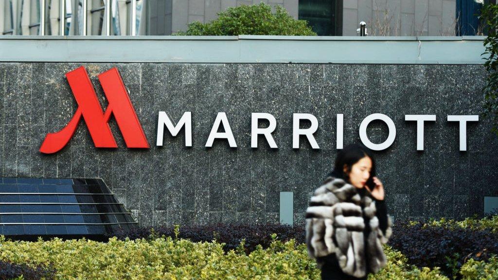 A woman walking past Marriott signage in Hangzhou in China's Zhejiang province.