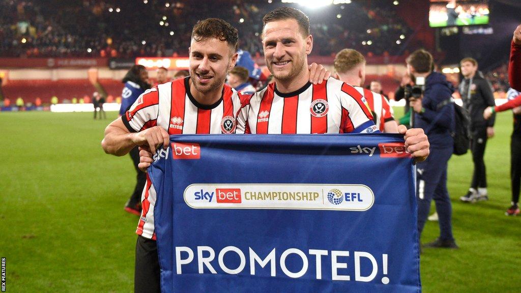 Sheffield United players George Baldock and Billy Sharp celebrating promotion