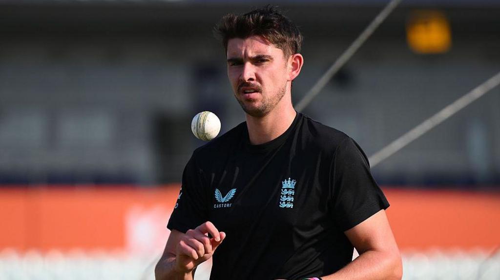 Josh Tongue throws himself a catch before bowling in a warm-up session for England 