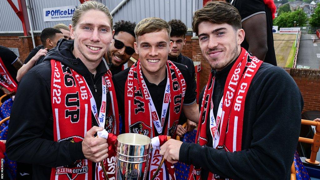 Alex Hartridge (left) with promotion-winning academy graduates Archie Collins (centre) and Josh Key