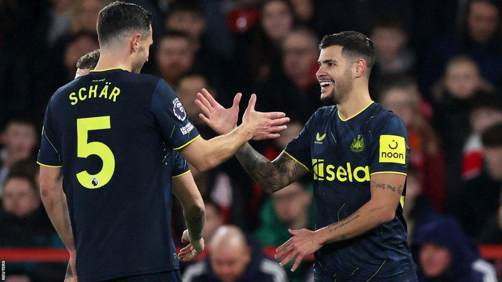 Bruno Guimaraes of Newcastle United celebrates with Fabian Schar