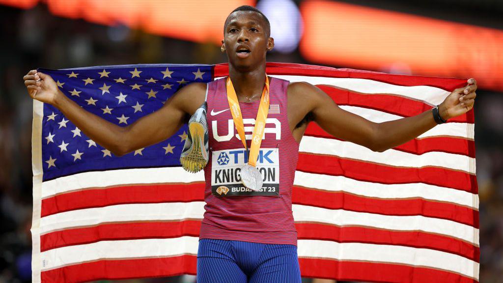 Erriyon Knighton celebrates with a US flag