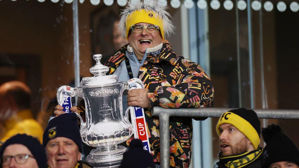 Timmy Mallett in football stadium with repica FA Cup