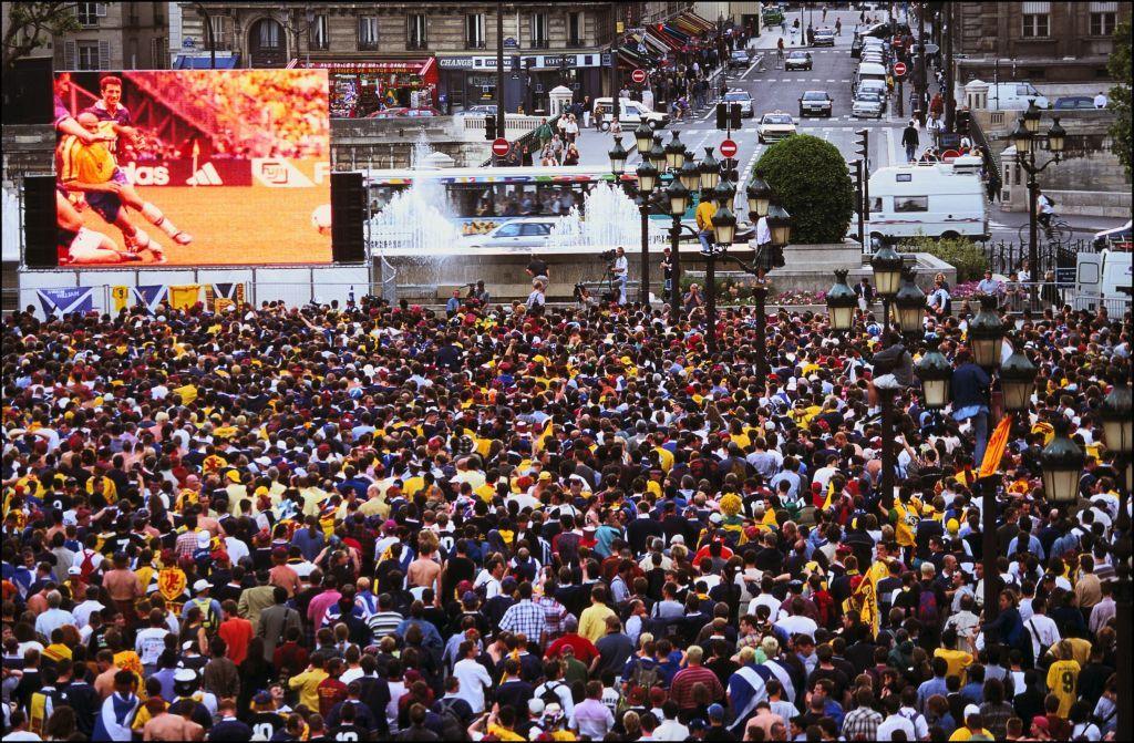 Thousands of Scots supporters flock to City Hall in Paris during the Brazil-Scotland match on 10 June 1998 - a sea of yellow and navy shirts watching the action on a big screen in the large public square.