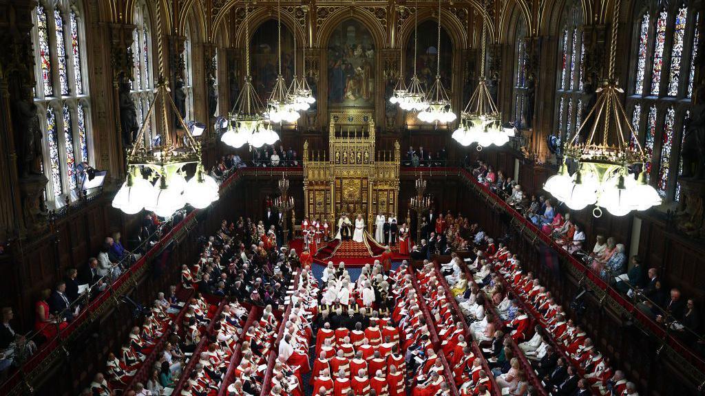 King Charles III, wearing the Imperial State Crown and the Robe of State reads the King's Speech in 2024.