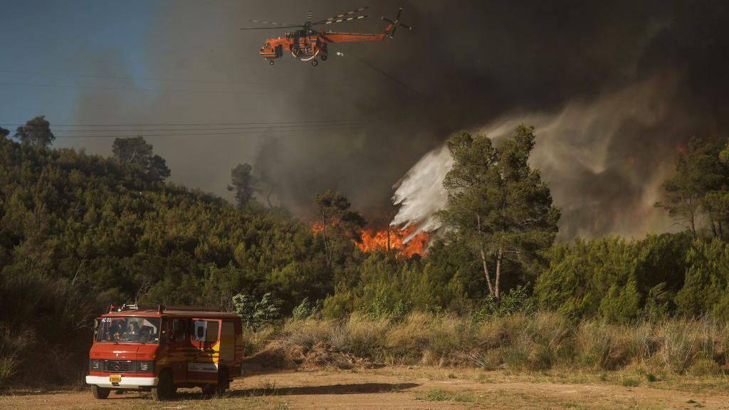 Fire engine and wildfire in Greece