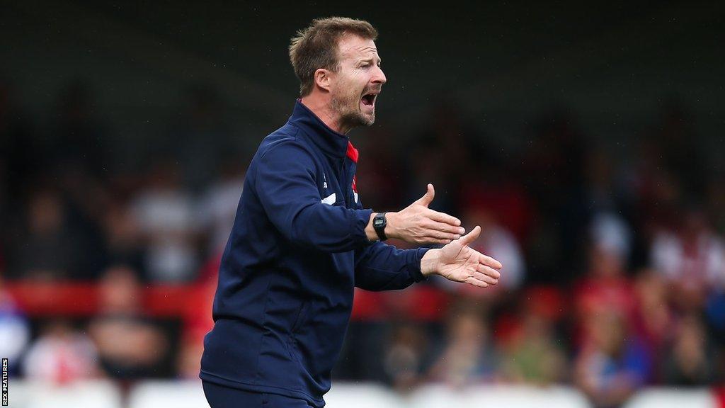 Wade Elliott shouts at his team from the touchline