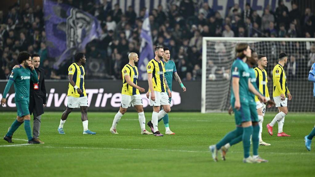 Players are taken off the pitch in the game between Anderlecht and Fenerbahce