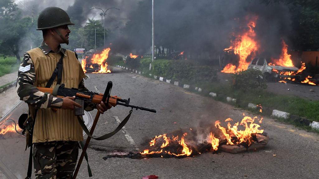 Indian police in riot gear gather to confront followers of Gurmeet Ram Rahim Singh, the controversial head of religious sect Dera Sacha Sauda (DSS), in his home base town of Sirsa on 25 August 2017