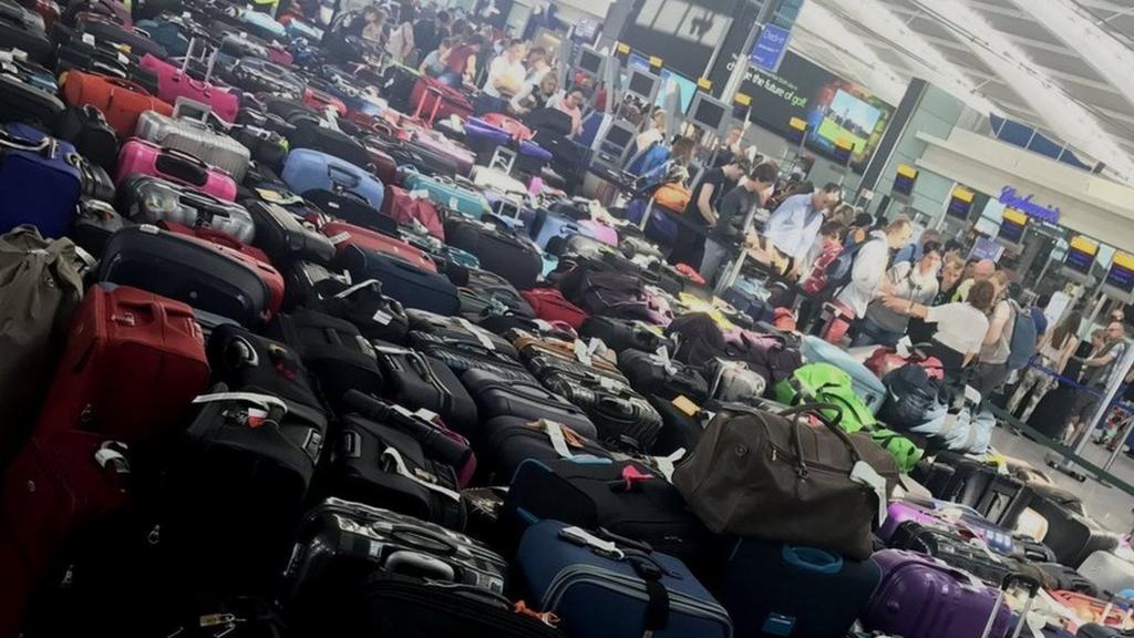 Piles of checked luggage on the floor in the Heathrow