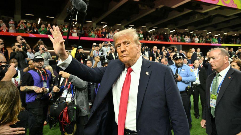 US President Donald Trump visits the field before the start of Super Bowl