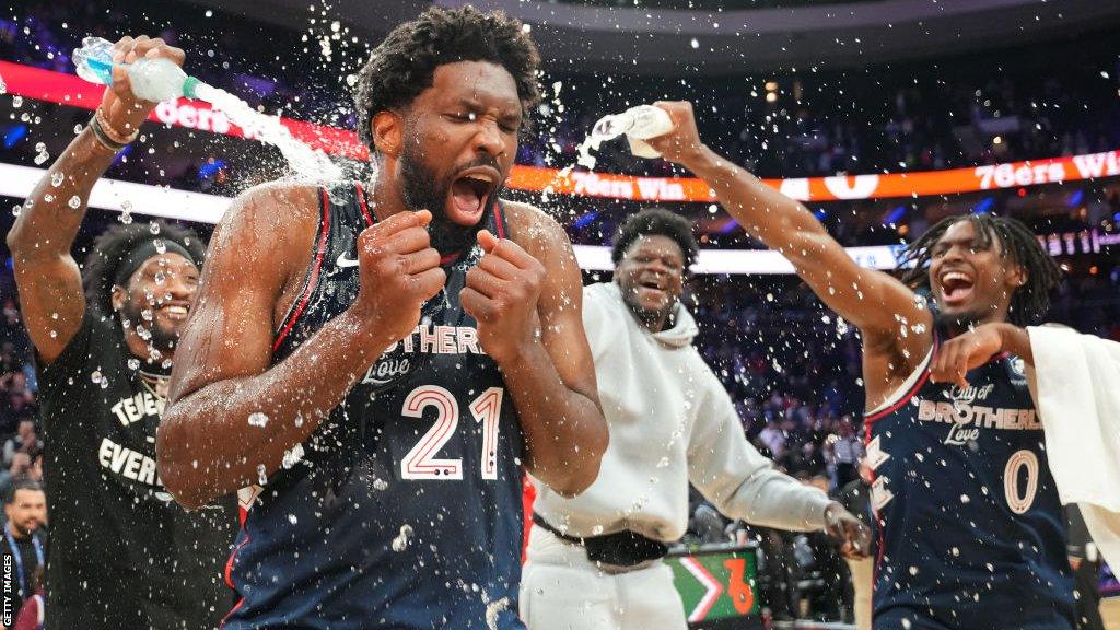 Joel Embiid being showered with water by his team-mates after breaking the 76ers scoring record