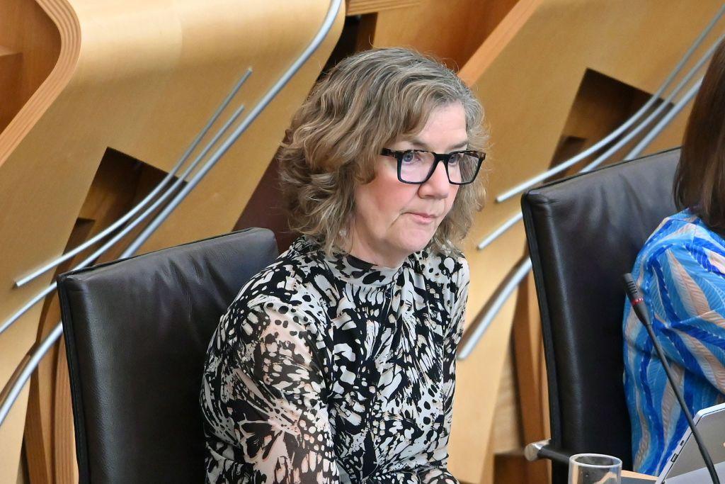 SNP MSP Audrey Nicoll - a middle-aged woman with glasses, wearing a black and white blouse - pictured in the Holyrood chamber.