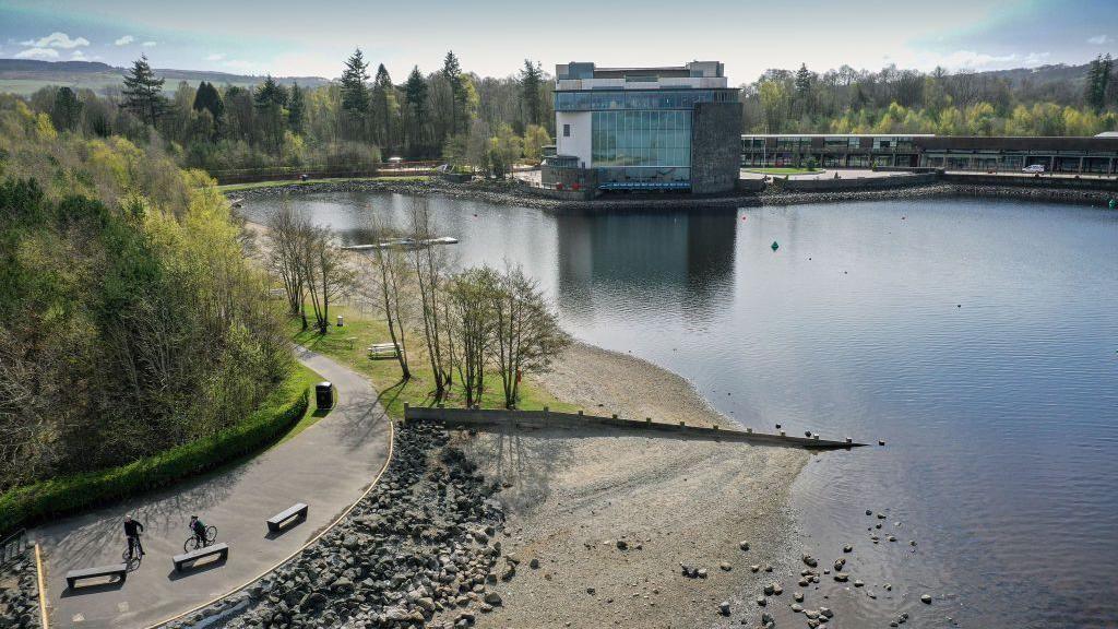 An aerial view of Loch Lomond in Balloch, West Dunbartonshire showing the shoreline and the Loch Lomond Shores development which includes shops, restaurants and the Sea Life Centre.