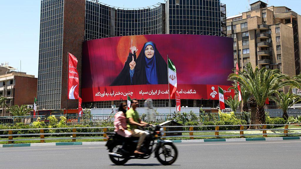 A banner of Iranian State TV presenter Sahar Emami, who was live on air during an Israeli attack, in Veliasr Square in Tehran on 17 June 2025.