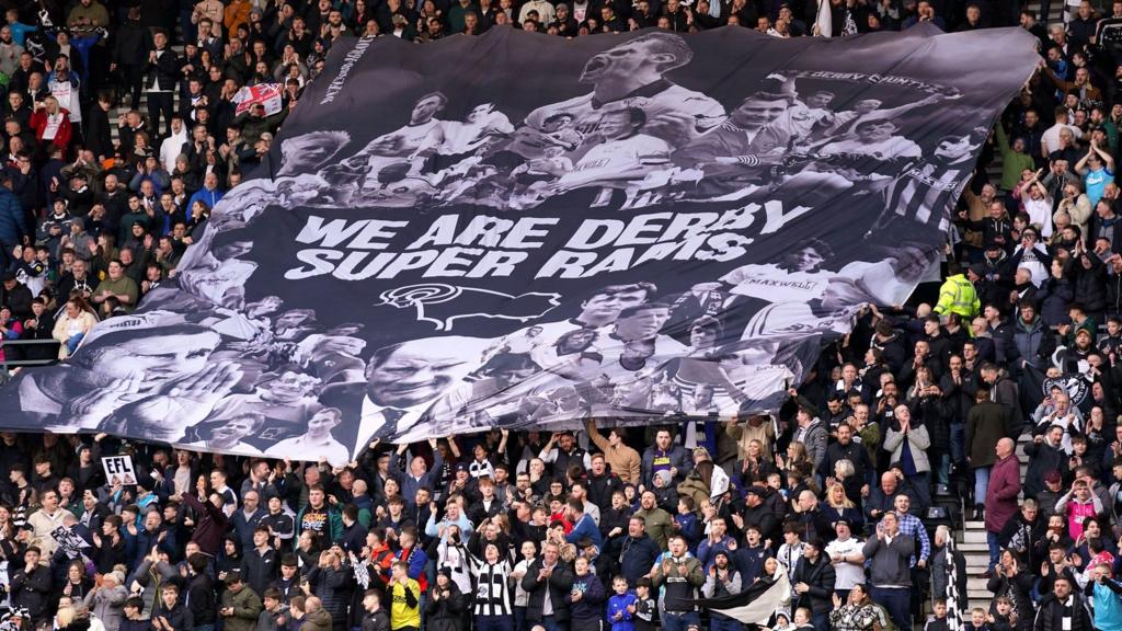 Derby fans with a banner