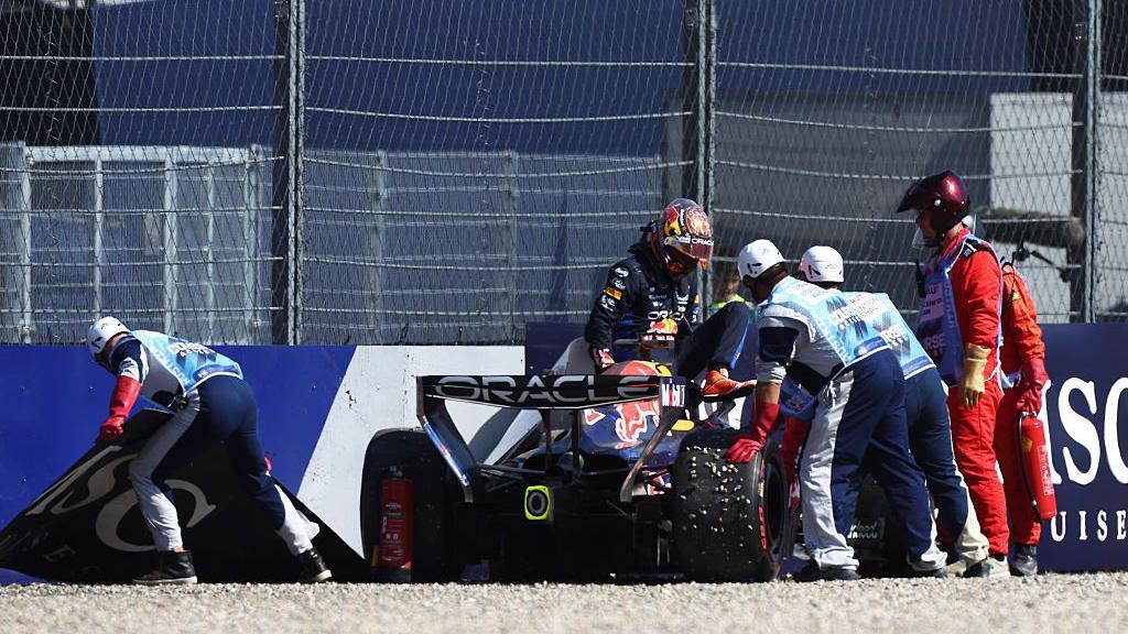 Max Verstappen climbs out of his Red Bull after crashing 