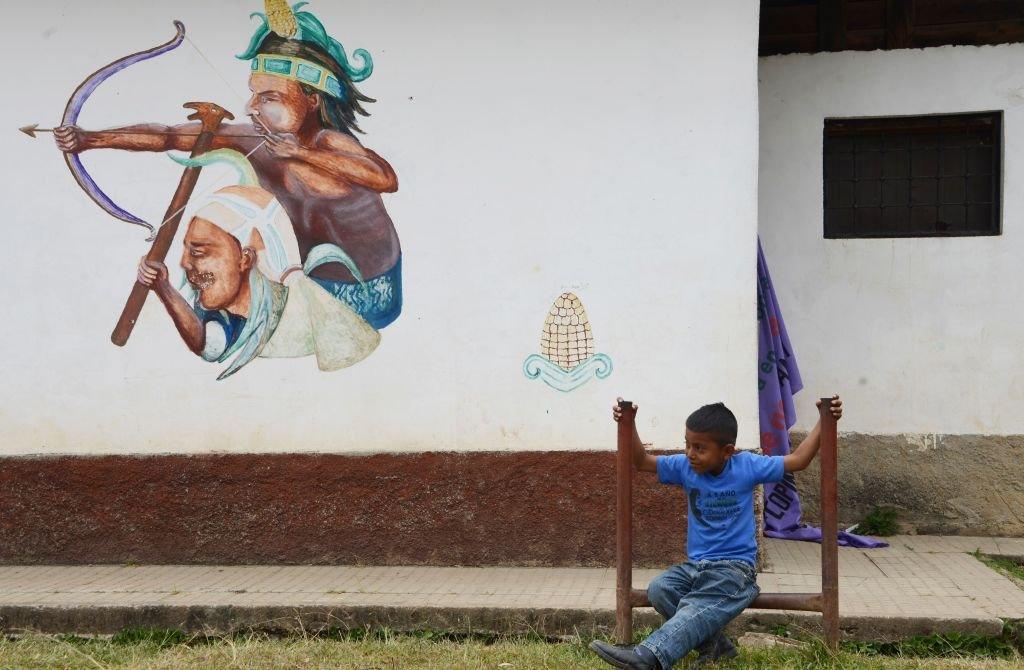 A Lenca indigenous boy sits near the cemetery where indigenous Honduran environmentalist Berta Caceres is buried, on the first anniversary of her murder, in La Esperanza, 180 km west of Tegucigalpa, on March 3, 2017