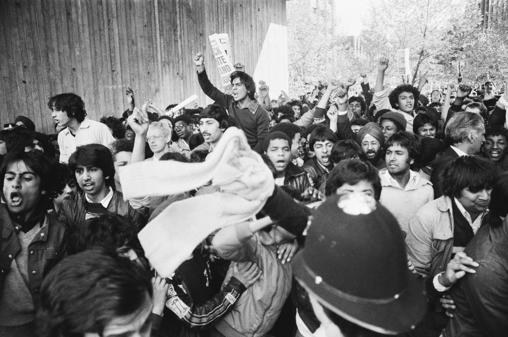 Black and Asian men who took part in a peace march in Coventry in May 1981 are pushed back by police officers