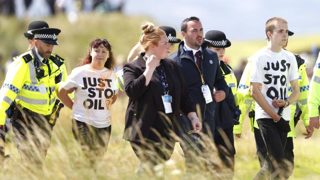 Protester is escorted away by police