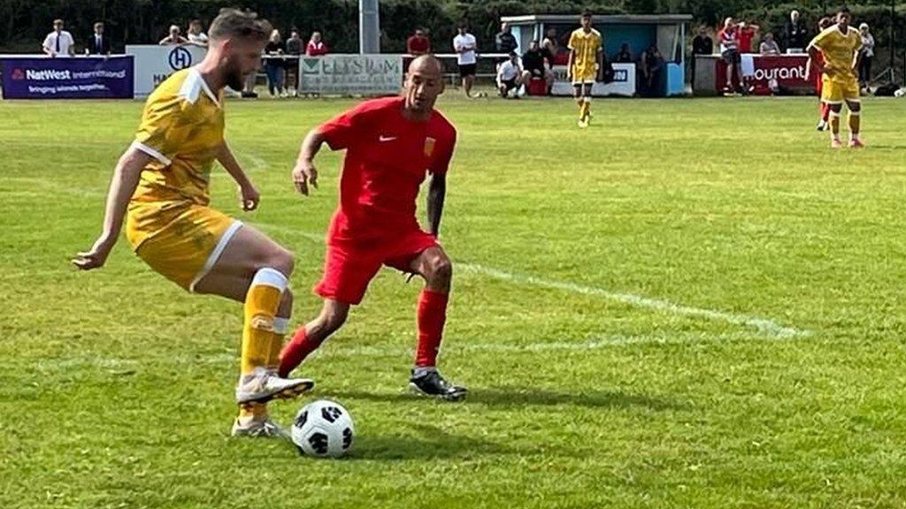 Jersey forward Karl Hinds pressurises a defender