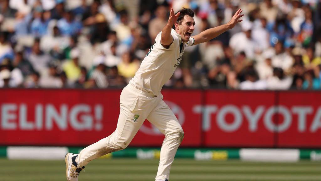 Pat Cummins celebrates a wicket v India