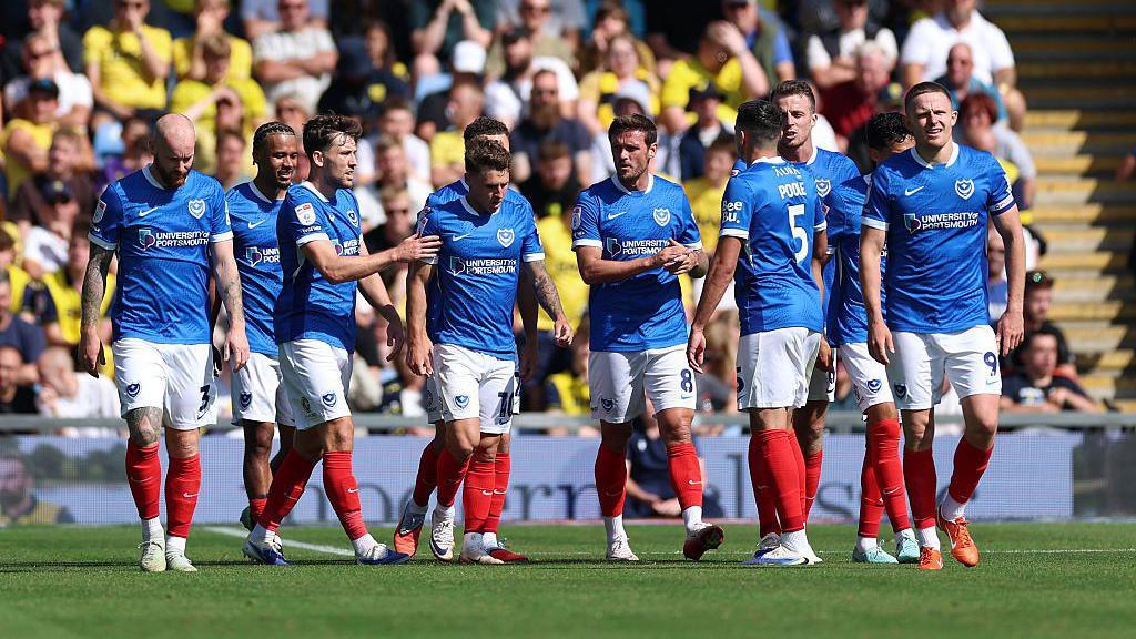 Portsmouth's team celebrate after taking the lead in the game 