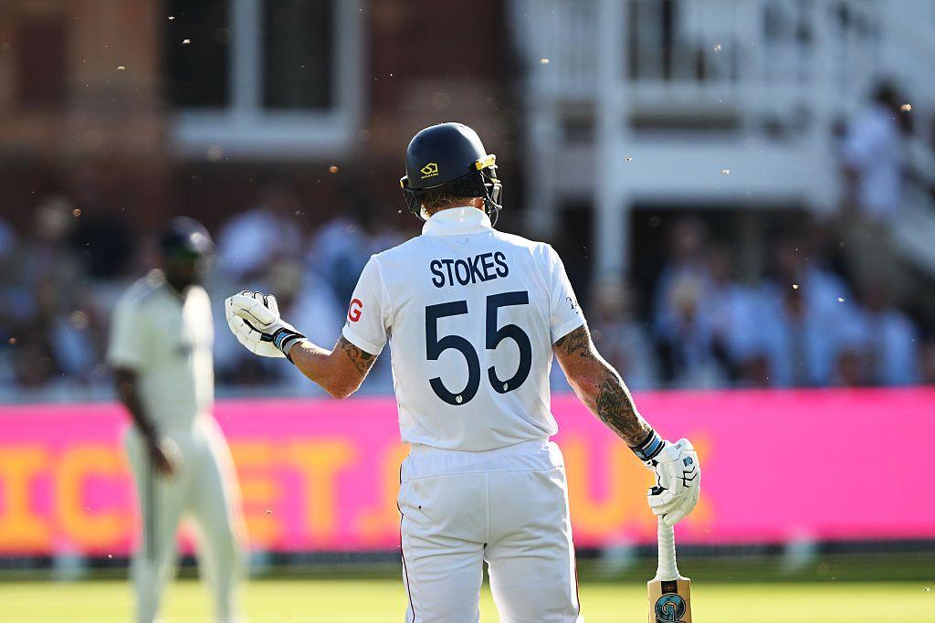 cricket player Ben Stokes holds up his hand while small insects appear to swarm about him at Lord's cricket ground