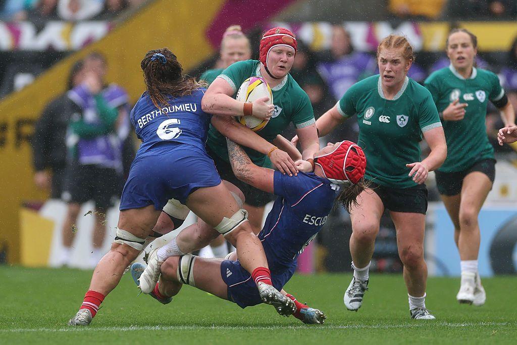 Aoife Wafer of Ireland is tackled by Axelle Berthoumieu and Charlotte Escudero of France during the Women's Rugby World Cup 2025 Quarter Final match between France and Ireland.