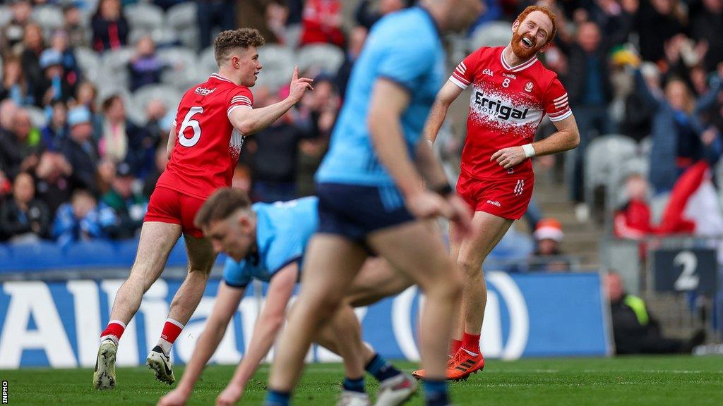 Eoin McEvoy scores one of Derry's goals in the Allianz League Final win over Dublin as team-mate and captain Conor Glass shows his delighted